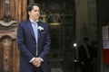 Groom waits for the bride at the church door