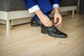 Groom is wearing shoes in blue wedding suit Royalty Free Stock Photo