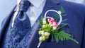 Groom wearing Wedding Boutonniere on Blue Suit - Buttonhole Royalty Free Stock Photo