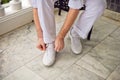 Groom wears white shoes. Wedding in the tropics concept Royalty Free Stock Photo