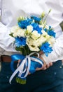 Groom with a wedding bouquet in hands