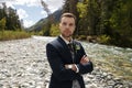 Groom at wedding tuxedo smiling and waiting for bride. Rich groom at wedding day. Elegant groom in costume and bow-tie Royalty Free Stock Photo