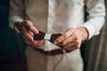 The groom in a white collar fixing his bow tie Royalty Free Stock Photo