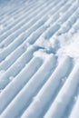 Groomed empty ski track, corduroy snow texture