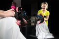 Groomer cuts a dog that sits in a chair doing grooming
