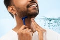 Close up of man shaving beard with razor blade Royalty Free Stock Photo