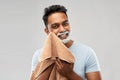 Man removing shaving foam from face by towel Royalty Free Stock Photo