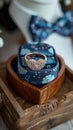 Grooms details rings in wooden box on heart shaped stand