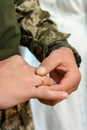 Grooms wear their wedding rings on their fingers. Groom in military uniform.