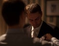 Groomsman fixing boutonniere