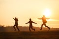 Groomsmen playing fool in the rays of sunset somewhere on the field