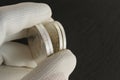 Grooved coin edges. Silver coins in the hand of a numismatist.