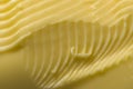 Grooves and swirls made by a kitchen knife taking margarine to spread