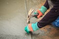 Grooving on concrete pavement by worker used deformed steel bar