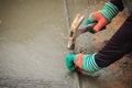 Grooving on concrete pavement by worker used deformed steel bar