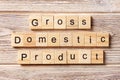 Gross domestic product word written on wood block. GDP text on table, concept