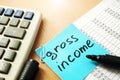 Gross income written on a stick.