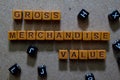 Gross Merchandise Value on wooden cubes. On table background