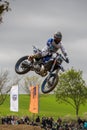 Gross Schwiesow, Germany - March 01,2019 - Motocross racer making a stunt and jumps in the air over a sand hill