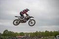 Gross Schwiesow, Germany - March 01,2019 - Motocross racer making a stunt and jumps in the air over a sand hill