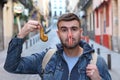 Grossed out man cleaning an excrement