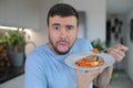 Grossed out man disliking his meal Royalty Free Stock Photo