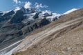 Grossglockner mountain lake rocks and yellow flowers in the foreground in the Austrian Alps in the Hohe Tauern mountains Royalty Free Stock Photo