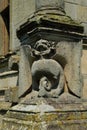 Grotesque gargoyle carving in stone on an old house