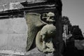 Grotesque gargoyle carving in stone on an old house