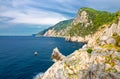 Grotta di Lord Byron with blue water, coast with rock cliff, yellow boat and blue sky near Portovenere town, Ligurian sea, Riviera