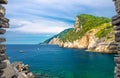 Grotta di Lord Byron with turquoise water and coast with rock cliff through stone wall window, Portovenere town, Ligurian sea, Riv