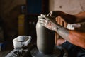 Close-up of the hands of the craftsman while creating a ceramic pot on the lathe Royalty Free Stock Photo