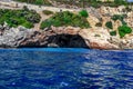 A grotto in a rock under the highway to Alanya Turkey - view from the sea. Large cave with concrete blocks inside against the Royalty Free Stock Photo