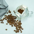 Ground, a bag for coffee drops and a transparent mug on the table. Drop coffee on a gray background with coffee beans. coffee Royalty Free Stock Photo