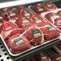 And ground beef, each labeled with a green halal certificatio Royalty Free Stock Photo