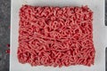 Ground beef. Fresh Raw mince, Minced beef, ground meat with herbs and spices on black plate Royalty Free Stock Photo