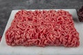 Ground beef. Fresh Raw mince, Minced beef, ground meat with herbs and spices on black plate Royalty Free Stock Photo