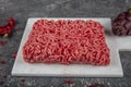 Ground beef. Fresh Raw mince, Minced beef, ground meat with herbs and spices on black plate Royalty Free Stock Photo