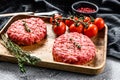 The ground beef patties, minced meat cutlets. Gray background. Top view Royalty Free Stock Photo