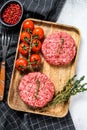 The ground beef patties, minced meat cutlets. Gray background. Top view Royalty Free Stock Photo
