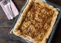 Ground beef pizza with cheese on a baking sheet isolated on dark wooden background. Table top view Royalty Free Stock Photo