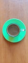 ground black coffee on a green plate on a brown table Royalty Free Stock Photo