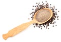 Ground black pepper in a spoon and peppercorns on a white background isolated. The view from top Royalty Free Stock Photo