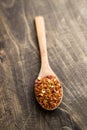 Ground cayenne pepper in wooden spoon