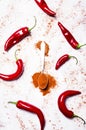 Ground chili and fresh red hot pepper, spice background, top vie Royalty Free Stock Photo