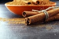 Ground cinnamon, cinnamon sticks, tied with jute rope and cinnamon powder in rustic style Royalty Free Stock Photo