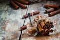 Ground cinnamon, cinnamon sticks, tied with jute rope on old woo Royalty Free Stock Photo