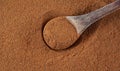 Ground cinnamon with old wooden spoon, top view Royalty Free Stock Photo