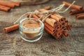 Ground cinnamon, cinnamon sticks, tied with jute rope on old wooden background in rustic style. Royalty Free Stock Photo