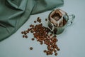 Ground coffee, a bag for coffee drops and a transparent mug on the table. Drop coffee on a gray background with coffee beans. Royalty Free Stock Photo